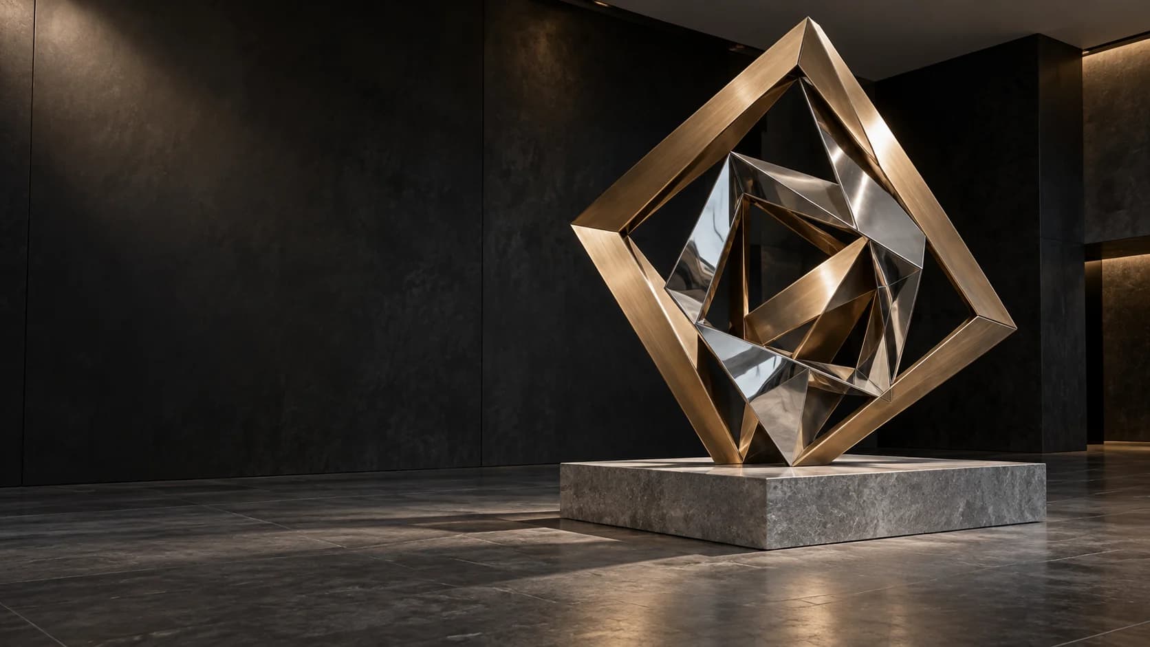 Geometric bronze and reflective metal sculpture in a dark architectural setting